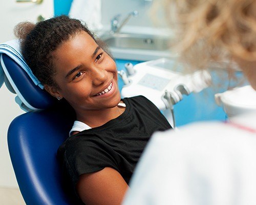 Adolescent girl smiling in dental chair