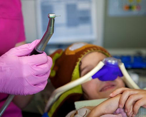 Child in dental chair with nitrous oxide mask