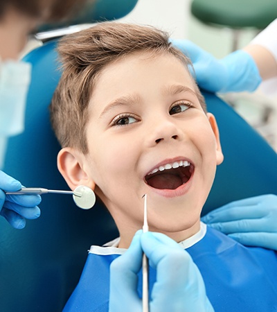 Boy smiling while seeing a Medicaid dentist in Center