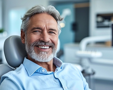 Older man smiling in the dentist’s chair