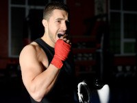 Man putting on mouthguard before boxing