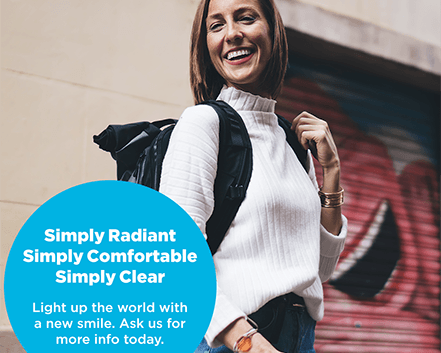 SimplyClear branded image showing happy woman wearing backpack