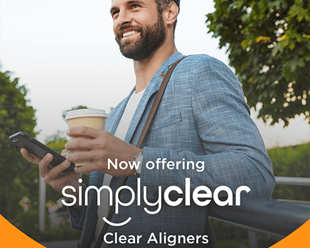 Branded SimplyClear image of confident man walking outside, holding a cup of coffee