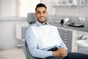 Man sitting in dental chair and smiling